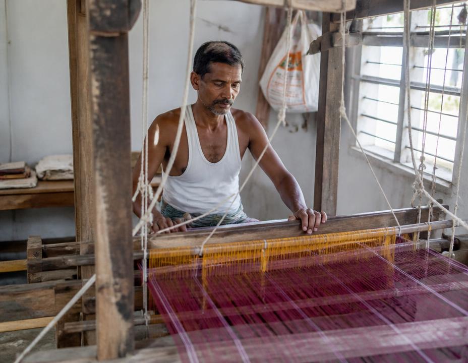 Handloom weaver working at a traditional loom